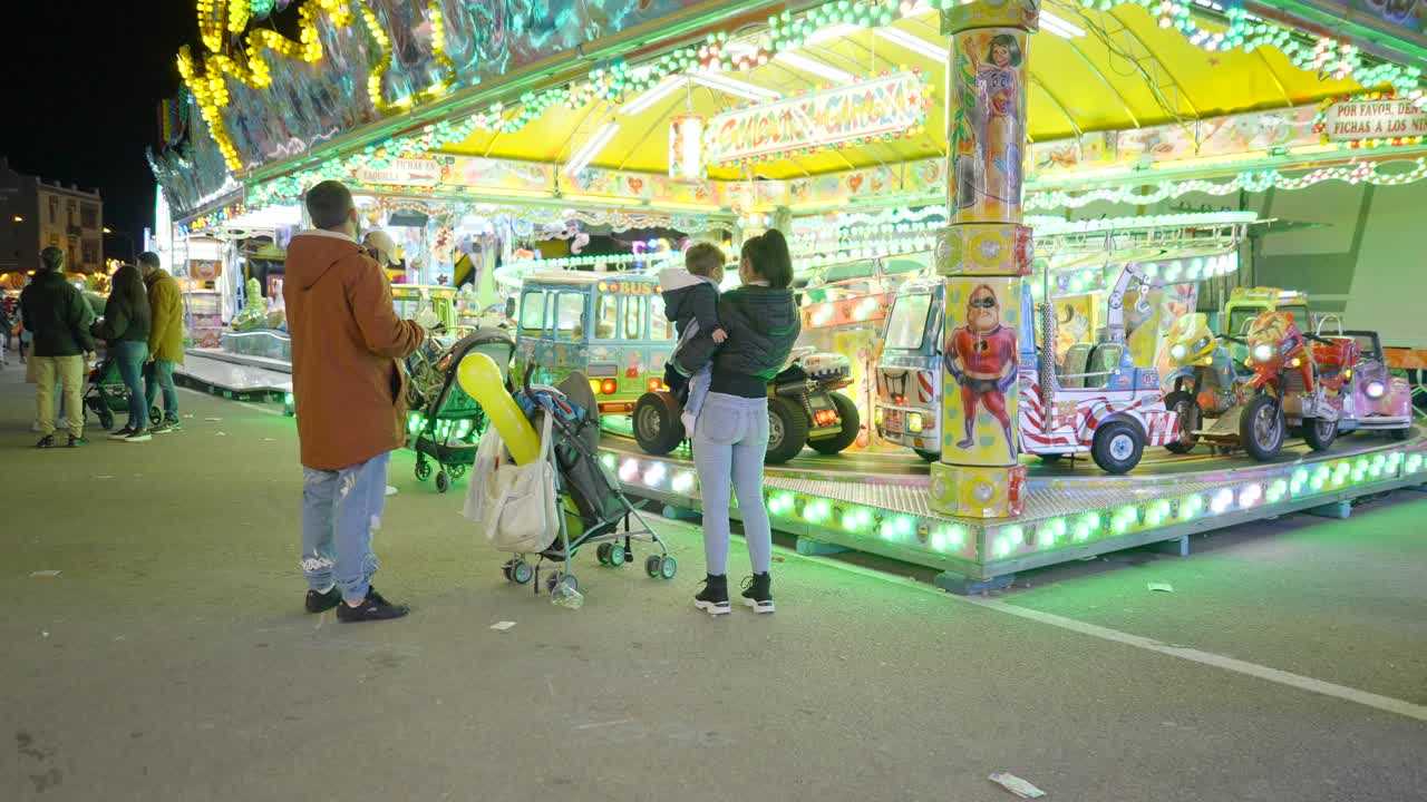 Family enjoying a night at a fun fair