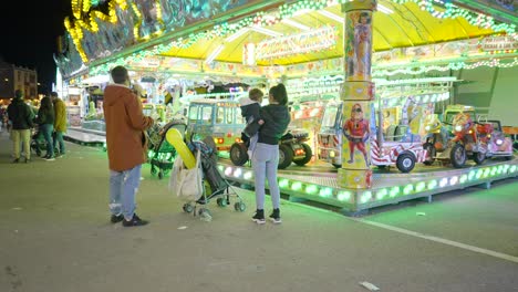 family enjoying a night at a fun fair
