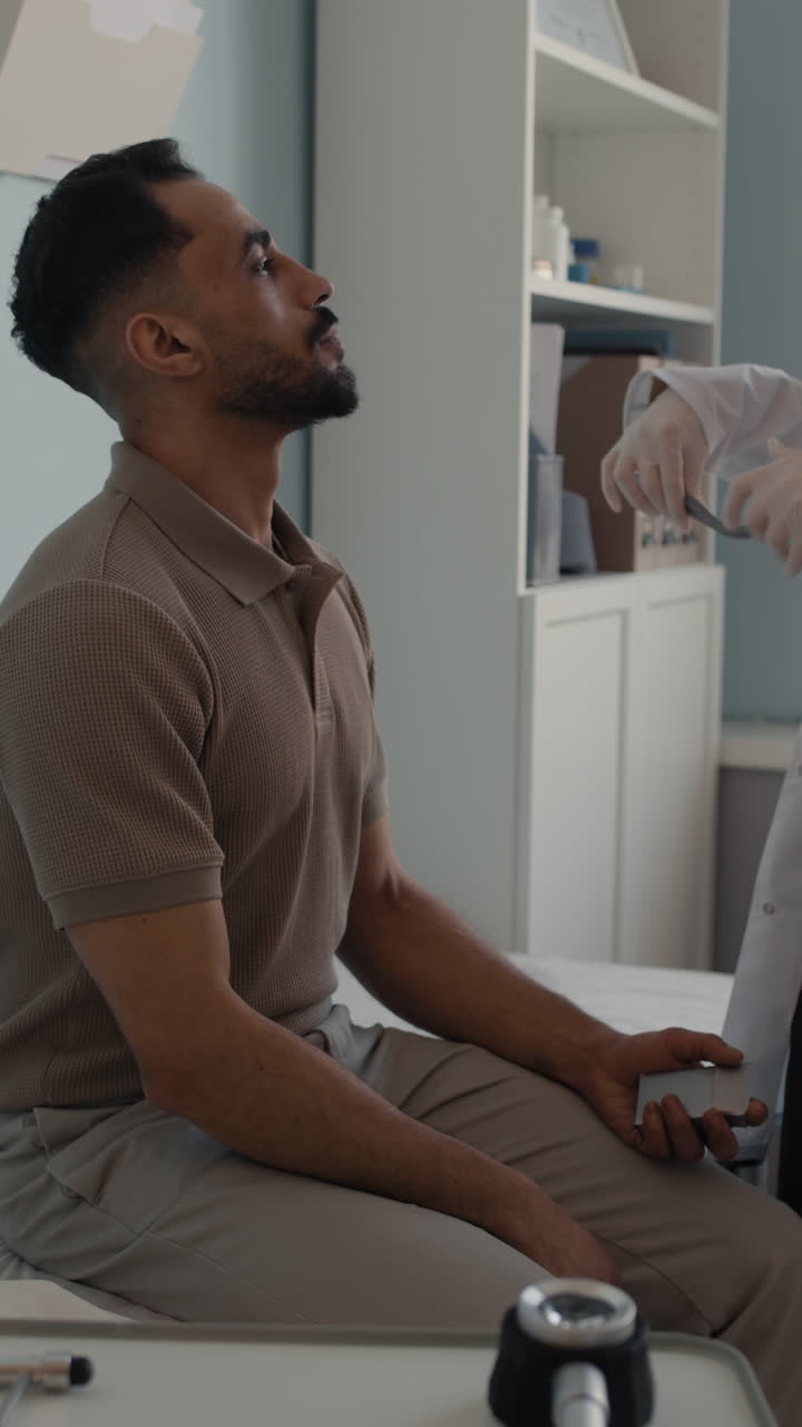 Doctor examining patient with stethoscope