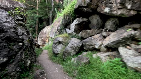 a narrow path through rocky terrain and greenery