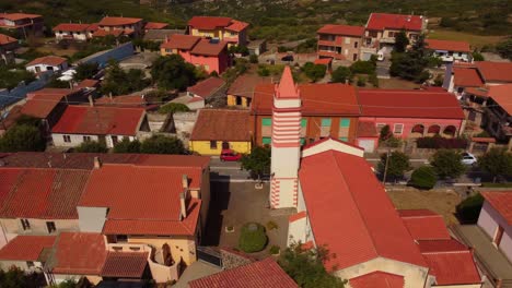 aerial shot orbiting around small church in tresnuraghes, sardinia, day