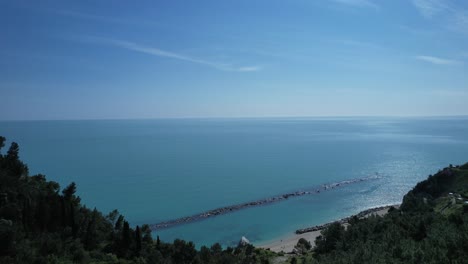 Adriatic-Sea-breaking-in-Spiaggia-del-Frate,-in-Numana-village,-Italy-drone-aerial-footage