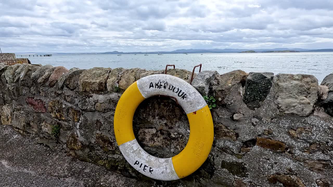 Life buoy attached to stone pier wall