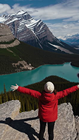 woman enjoying the view of a turquoise lake in the canadian rockies