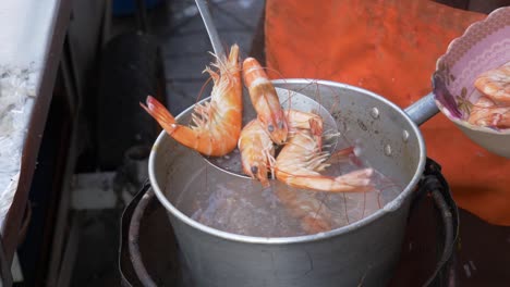 boiling shrimps in water at street food restaurant