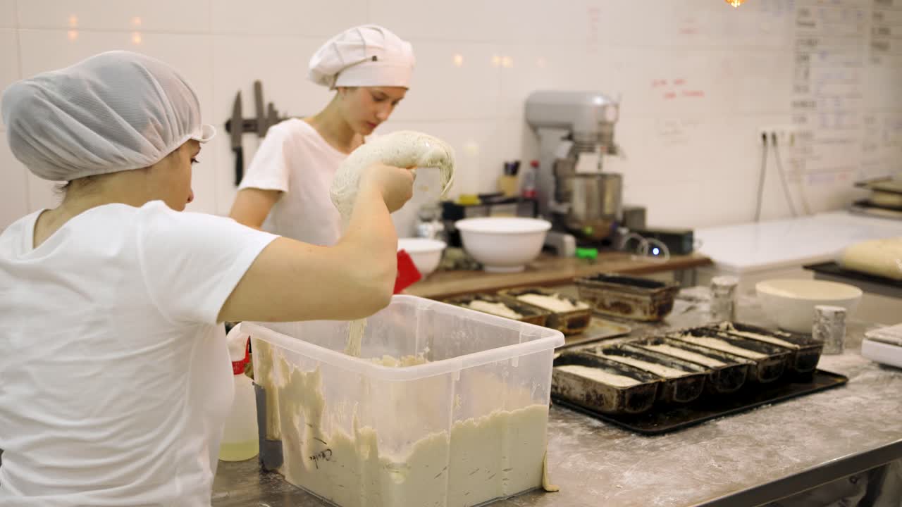 Two Women Bakers Preparing Dough in a Commercial Kitchen