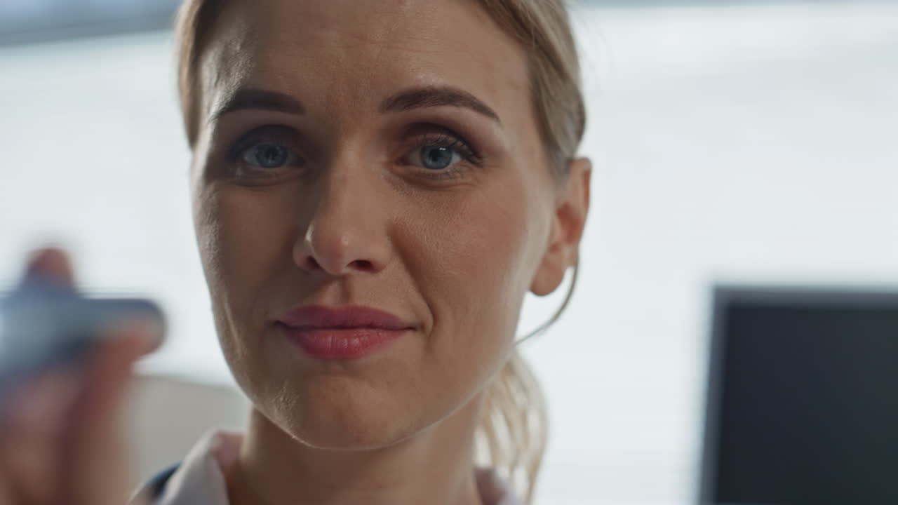 Closeup doctor using flashlight in clinic. Patient pov of medical examination