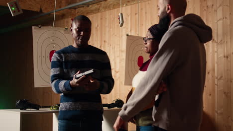 shooting gallery expert demonstrating how to safely reload pistol and cock gun