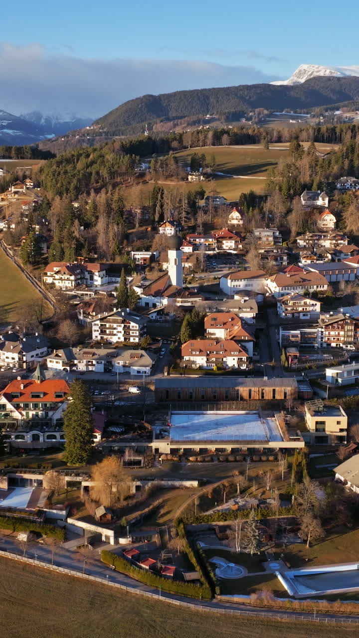 Aerial drone view of the Soprabolzano village on the Renon plateau in the Dolomites, Italy. Vertical