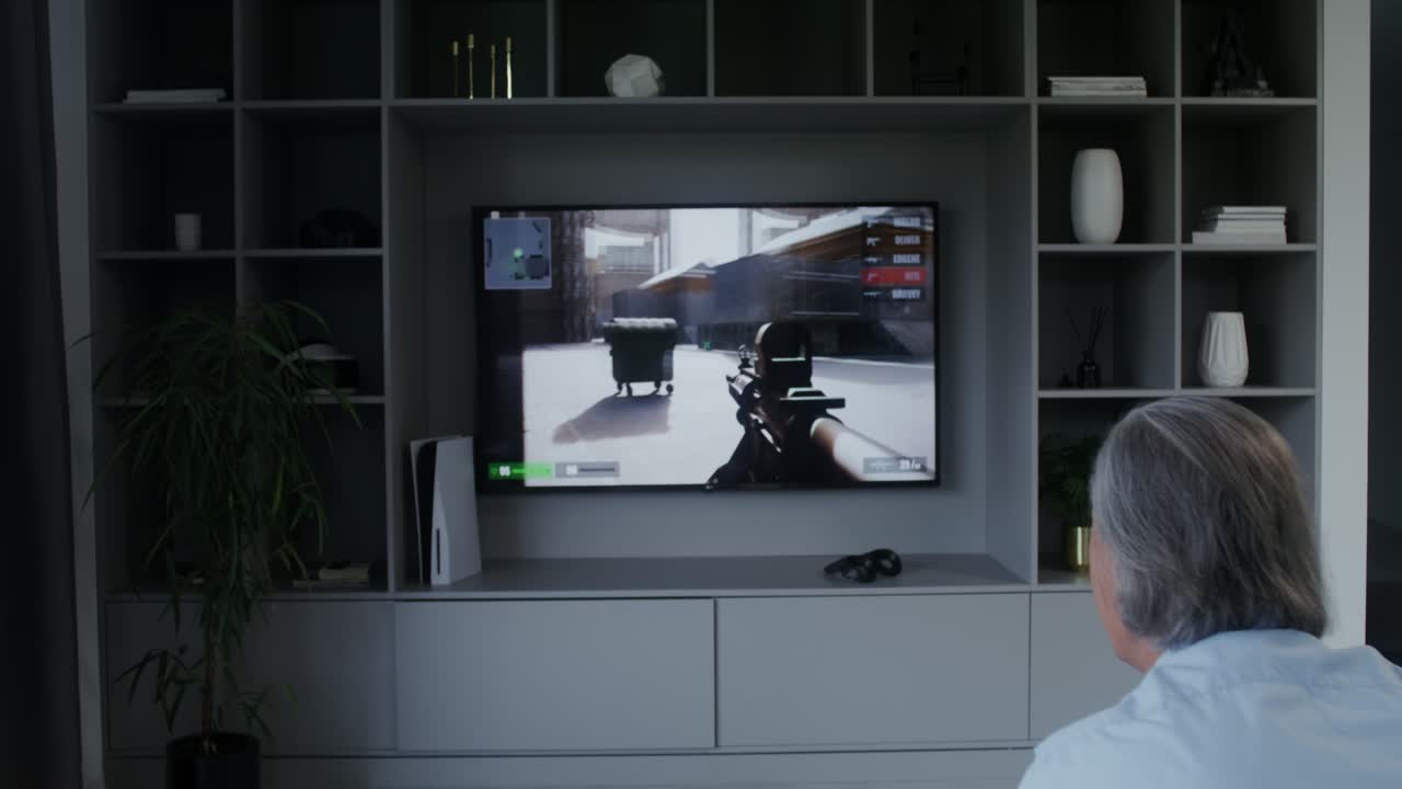 Man playing video game on TV