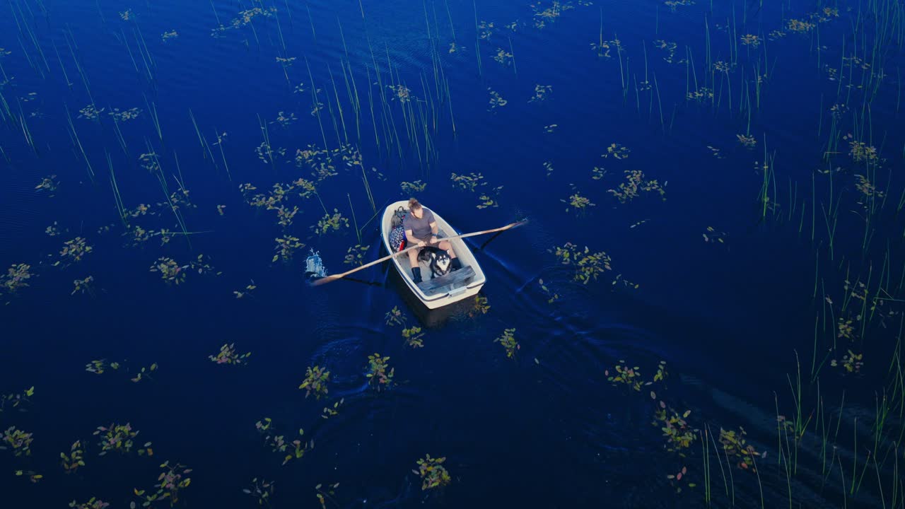 Top-down View Of A Small Rowboat Sailing In A Tranquil Water. Aerial Shot