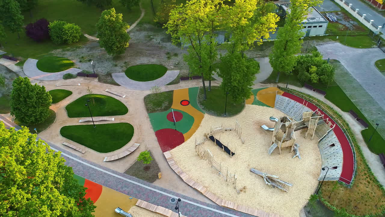 Aerial establishing overview of modern childrens play park area with innovative wooden jungle gym
