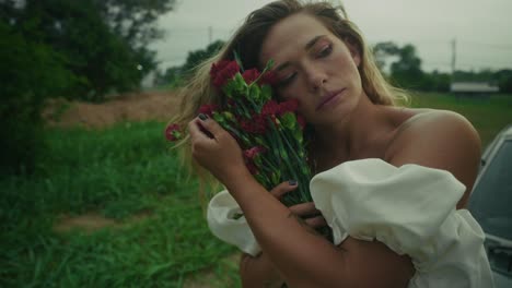 woman with carnations in a rural setting