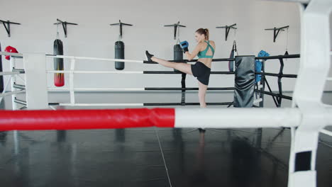 woman practicing boxing and kickboxing in a gym
