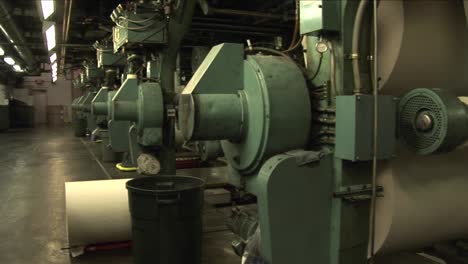 Workers-watch-paper-rollers-in-newspaper-factory