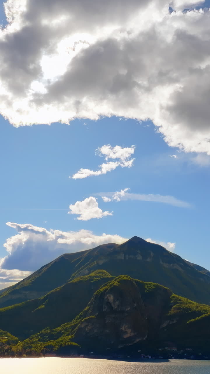 Aerial drone view of the Alps with a blue sky near Lake Como, Italy. Vertical