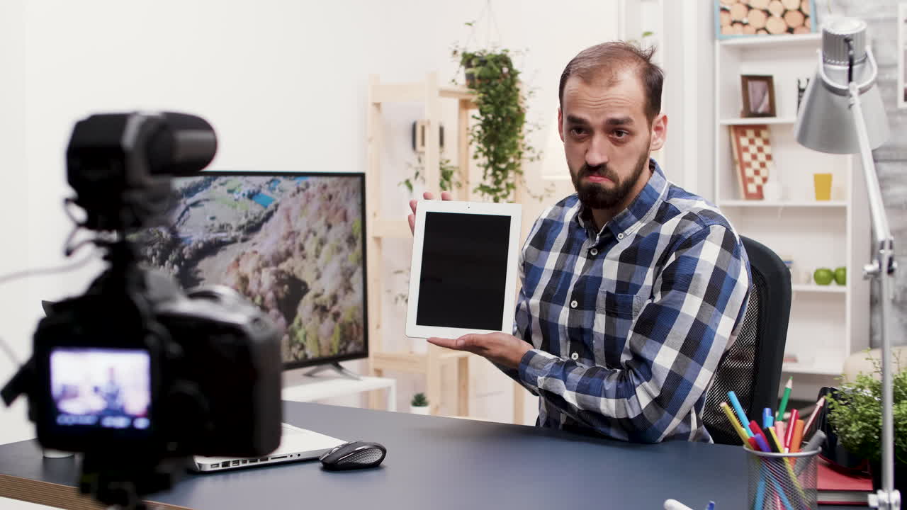 Man recording a vlog with a tablet