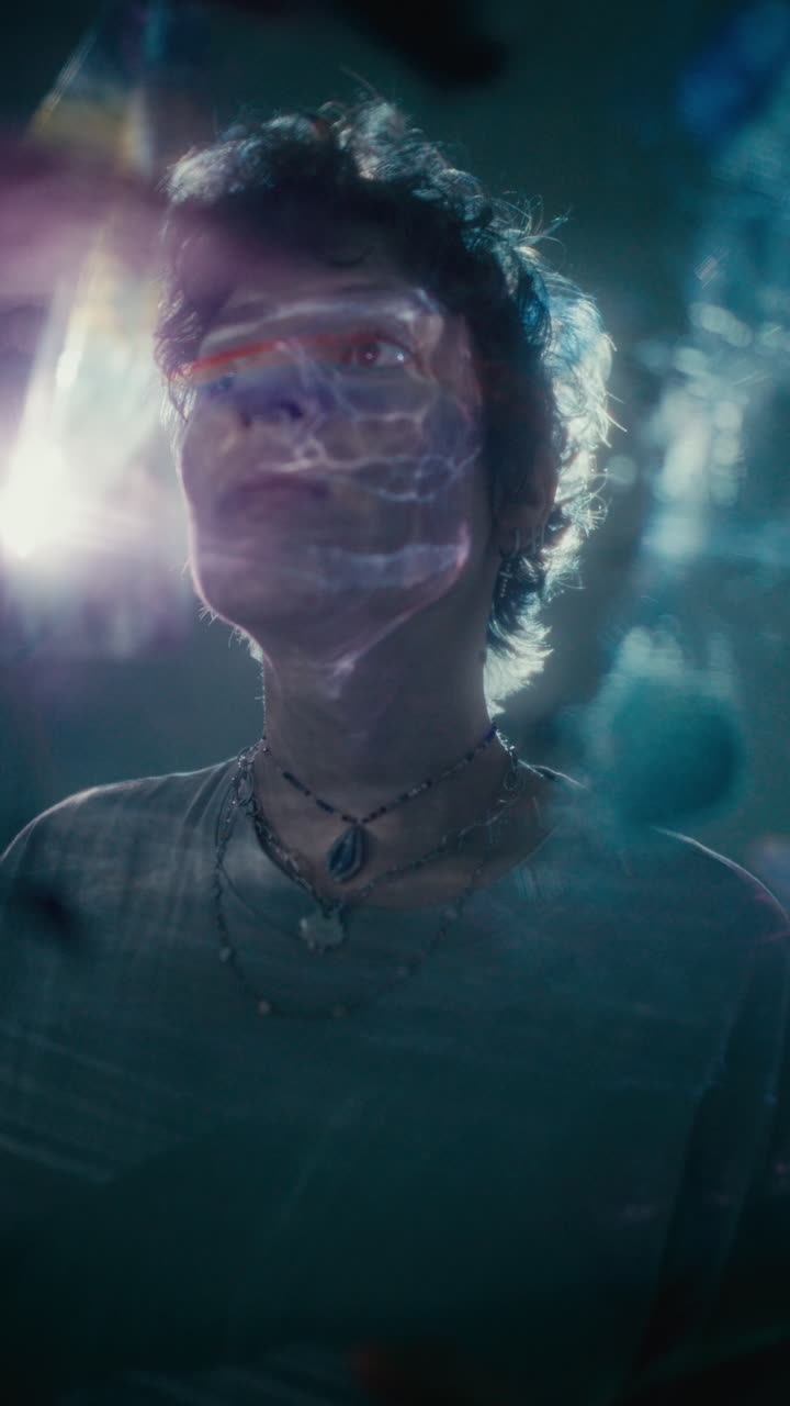 Portrait of Woman Illuminated by Ethereal Light Projection in Dark Room