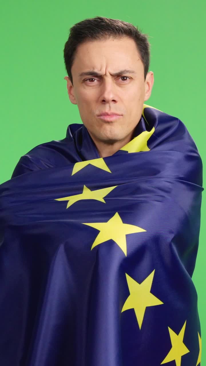 Proud european man wrapped in european union flag on green screen