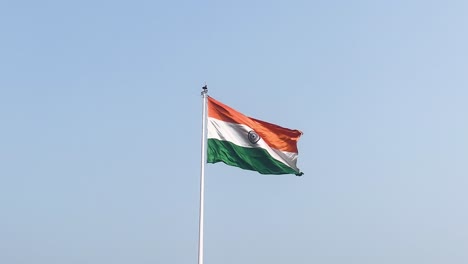 indian national flag with tri color waving and flying high in the blue sky