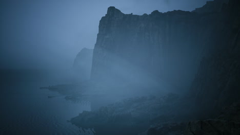 misty cliffs by the ocean create an atmospheric landscape at dusk