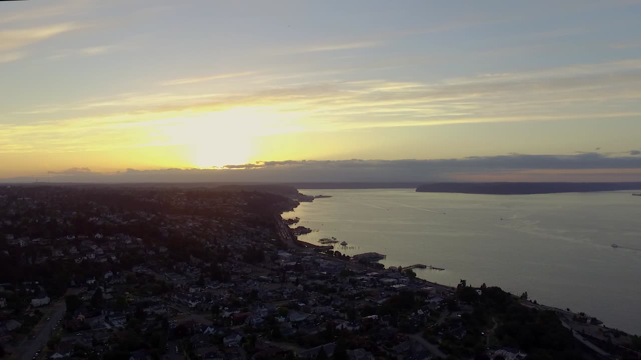 The beautiful bright orange sunset over the peaceful city of Tacoma, Washington - aerial