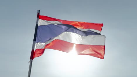close-up footage of the national flag of thailand, known as the tricolor or thong trairong, waving proudly in the wind. symbol of thai identity, patriotism, and national pride