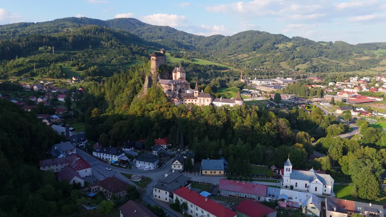 Aerial View of a Castle on a Hill Surrounded by a Town