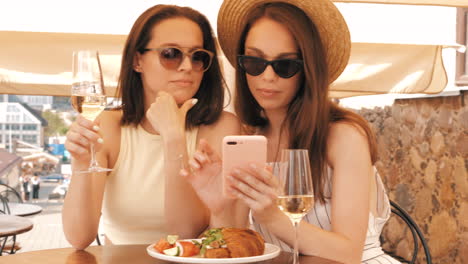 two friends enjoying lunch at an outdoor cafe