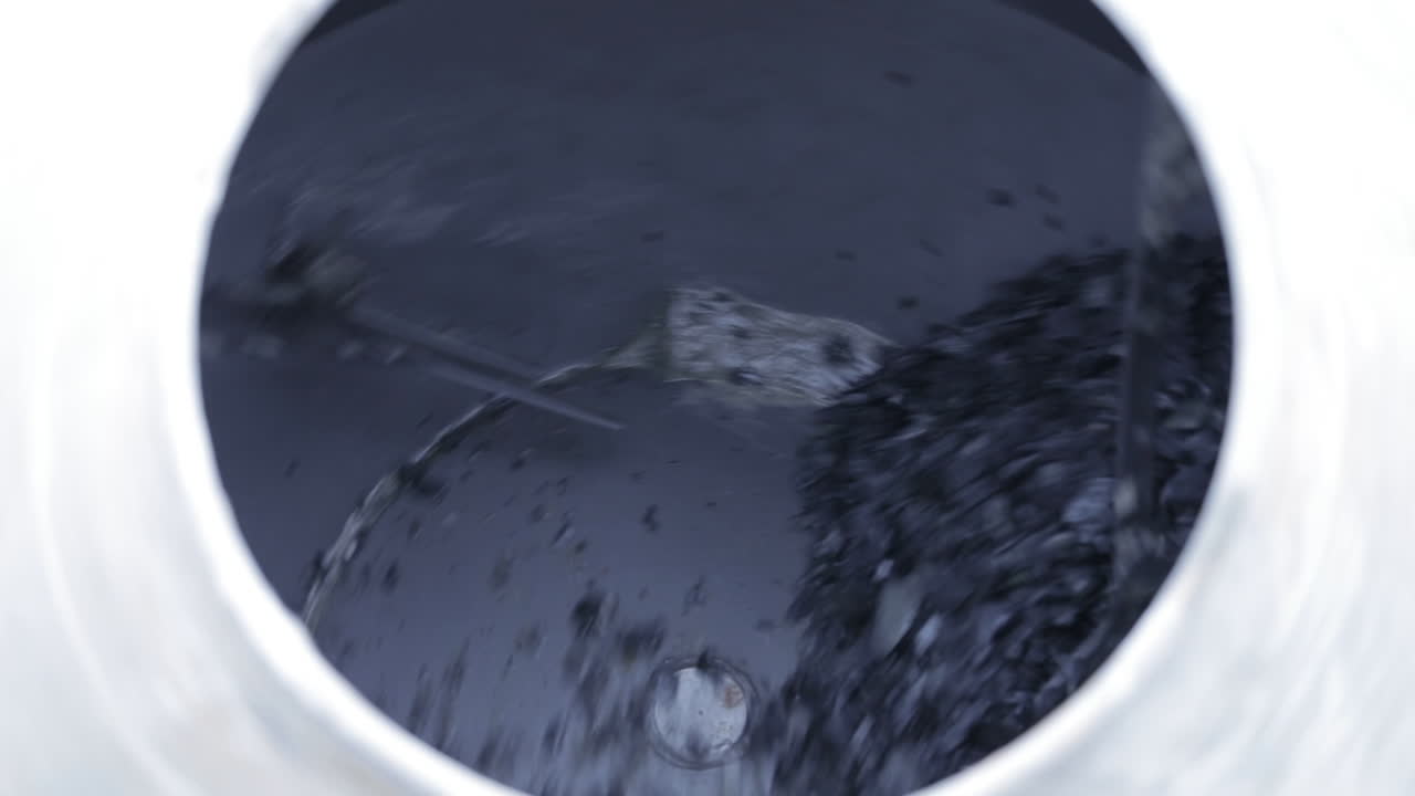 un trabajador de la construcción llenando una hormigonera en un sitio de construcción