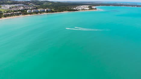 incredible blue sea with jet skis riding across the surface