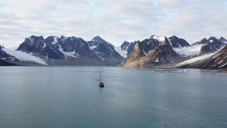 Sailing Boat And Mountain Range Over Spitsbergen Island In The Svalbard Archipelago In Norway. Aerial Drone Shot