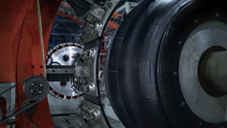 robotic tyre plant worker checking production process of technological machine