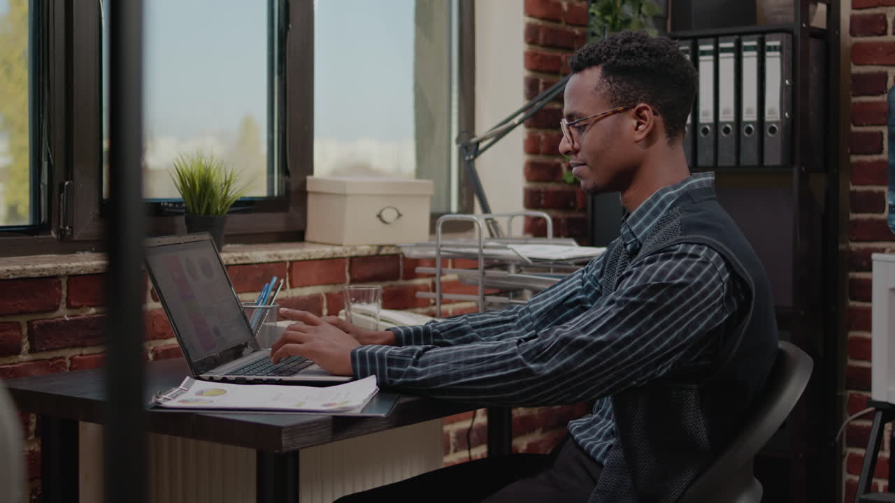 Manager using laptop to work on financial growth in office