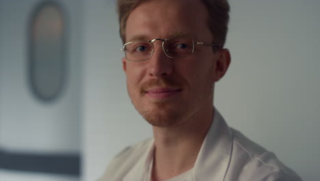 portrait handsome man doctor in cabinet. physician working using computer.