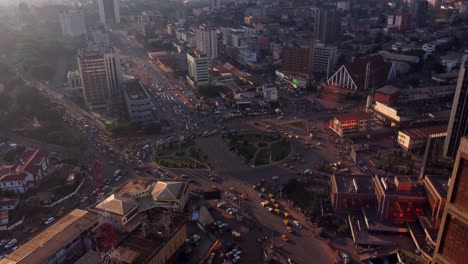 cinematic aerial of downtown yaounde, traffic at poste centrale roundabout