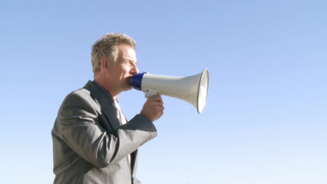 businessman giving instruction through a megaphone