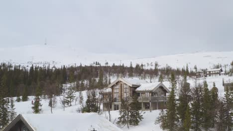 drone aerial view of a mountain cabin in bydalen, sweden