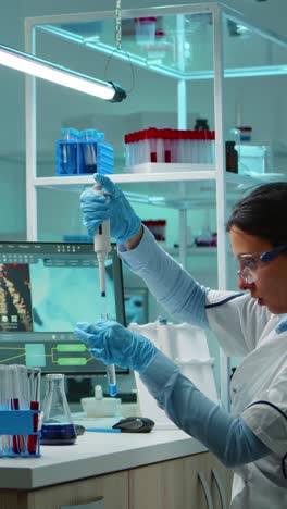 vertical video: scientist woman pipetting liquid to test tube