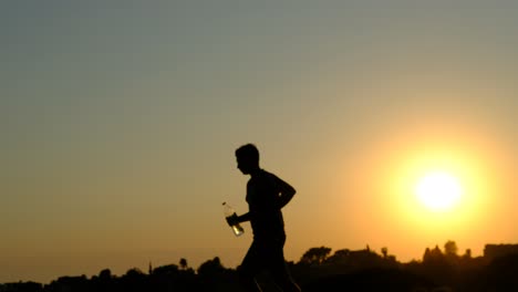 silhouette young man jogging