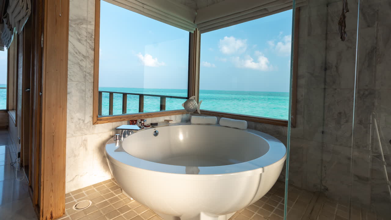 Time Lapse of Clouds and Tropical Sea on Window of Luxury Maldives Bungalow and Bathroom Bathtub