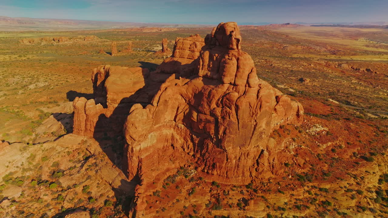Unusual sunlit mount with rounded edges in the middle of desert. Panning footage of beautiful rock in the Utah Canyons, USA.