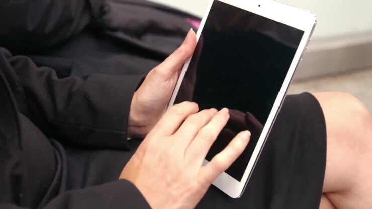 Donna d'affari che usa il tablet all'aperto
