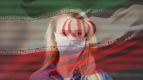 animación de la bandera de irán ondeando sobre una mujer que usa una máscara facial durante la pandemia de covid-19