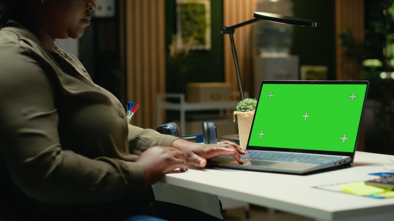 Chroma key display on laptop with black woman manager solving management