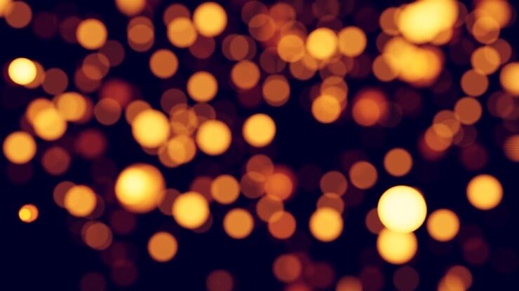 Luci bokeh dorate scintillanti su sfondo scuro