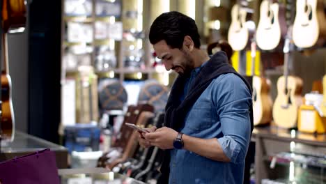 young man paying with qr code by smartphone contactless