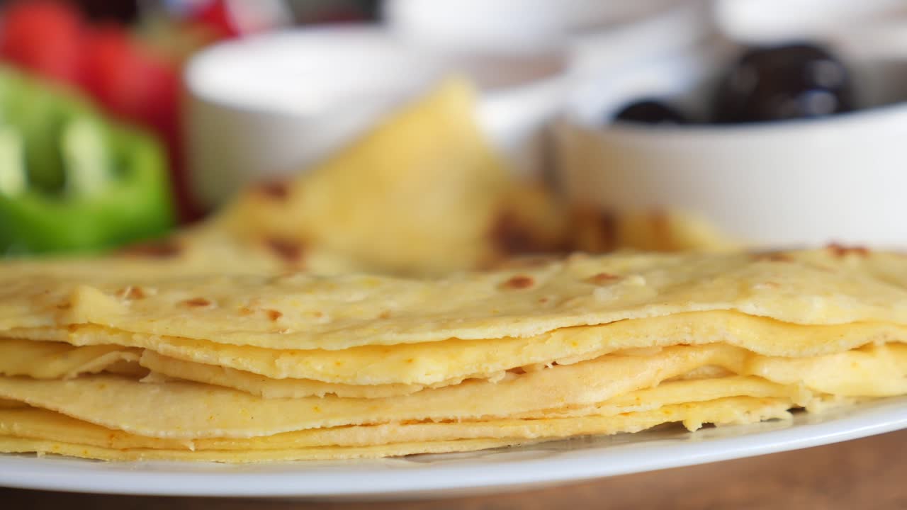 Stack of crepes with olives and vegetables