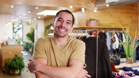 smiling hispanic man walks into focus in a clothes shop