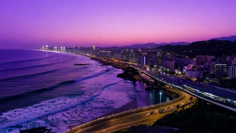 stunning sunset illuminates a coastal city, bathing buildings and beaches in a warm, golden glow